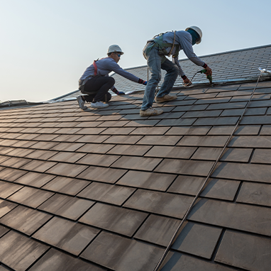 Workers installing roof